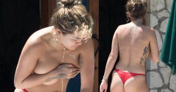 Topless Rita Ora showed her ample assets as she whipped off her bikini top to sunbathe in just a skimpy thong on Jamaican holiday